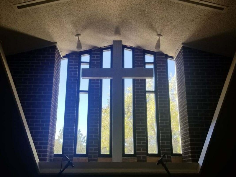 Church interior sanctuary window glass installation