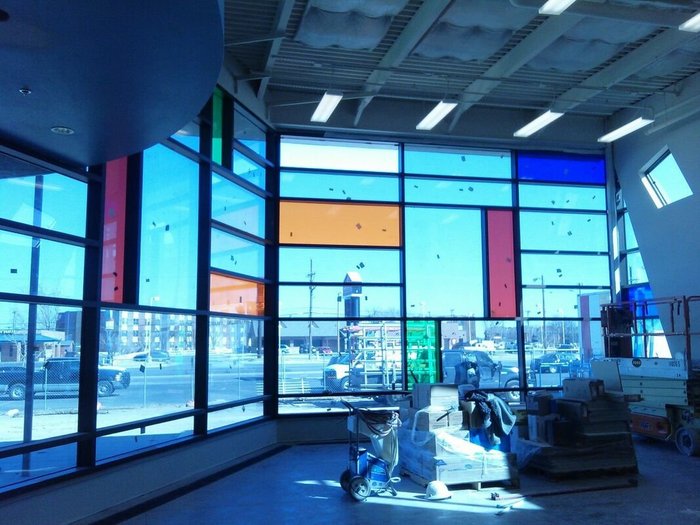 Colorful commercial storefront glass panel installation
