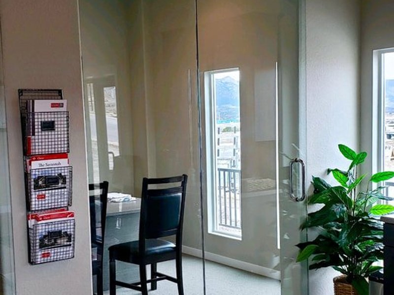 Frameless glass sliding door in a commercial office