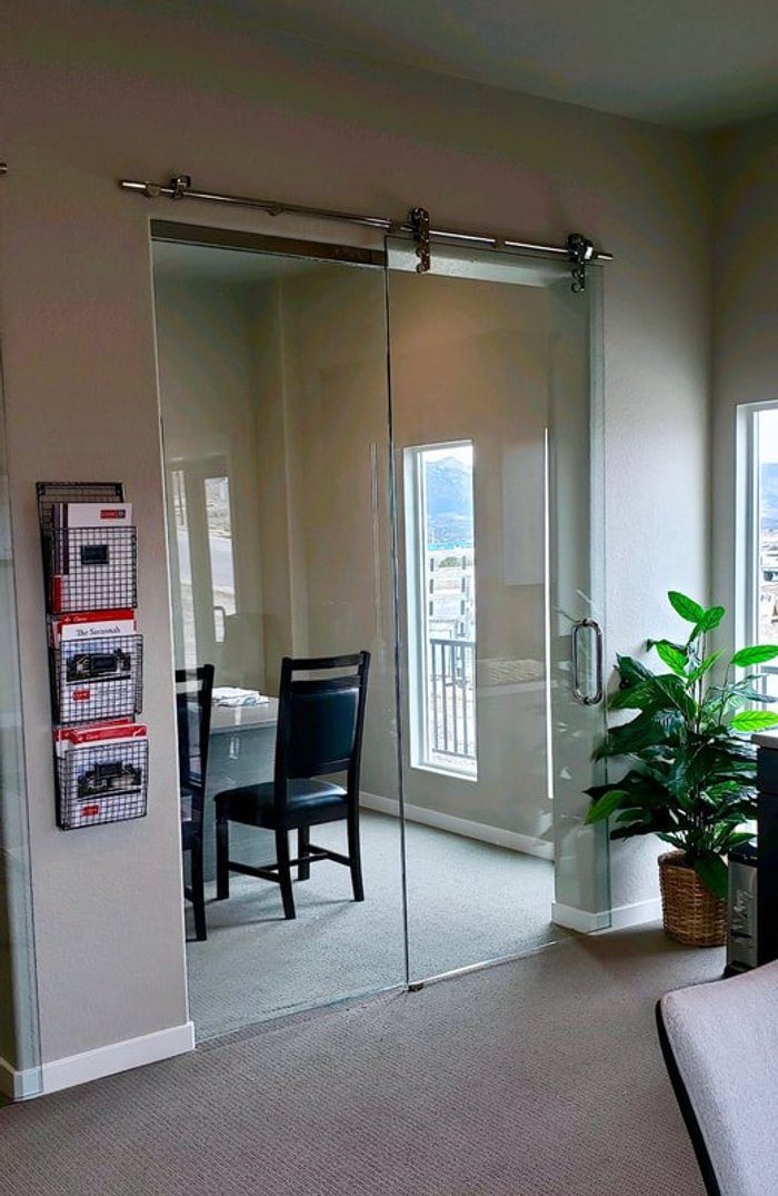 Frameless glass sliding door in a commercial office