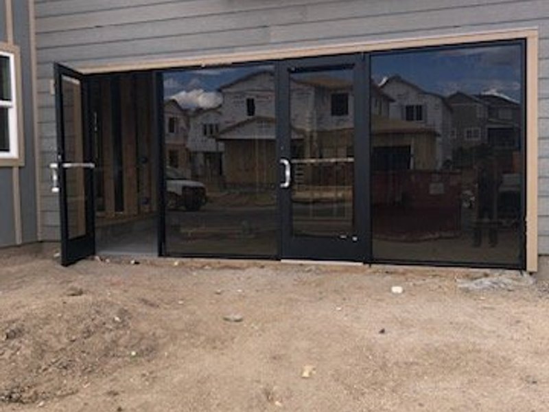 Commercial aluminum storefront with matte black framing on a new construction build by Kent Glass