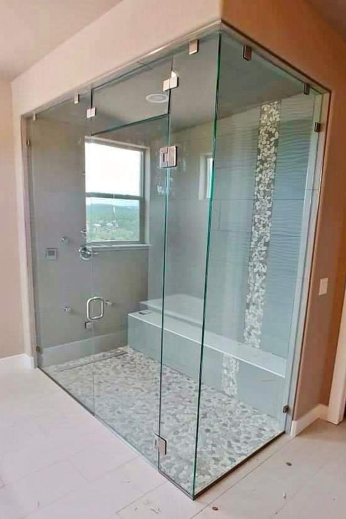 Floor-to-ceiling frameless steam shower enclosure with chrome clips