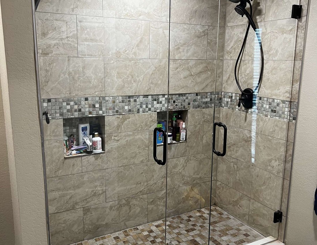 Frameless shower enclosure with matte black hardware by Kent Glass, Colorado Springs